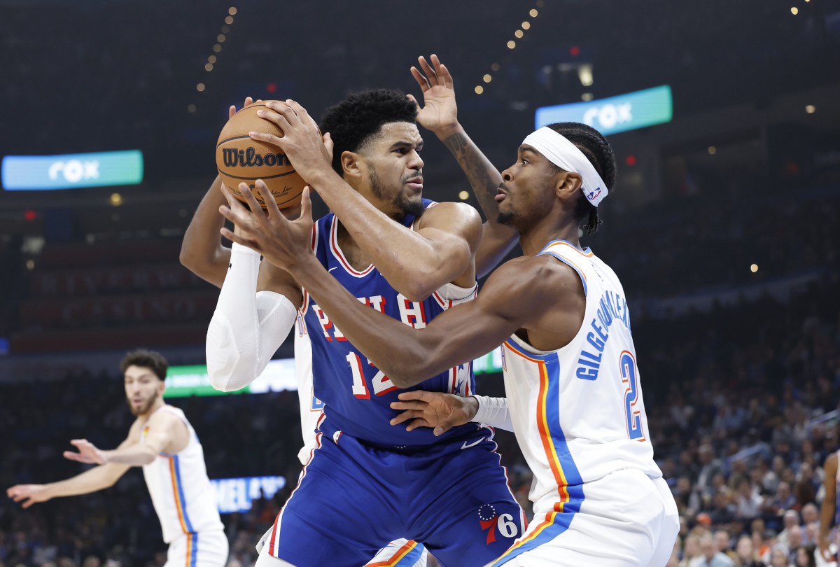 Nov 25, 2023; Oklahoma City, Oklahoma, USA; Oklahoma City Thunder guard Shai Gilgeous-Alexander (2) defends a drive by Philadelphia 76ers forward Tobias Harris (12) during the first quarter at Paycom Center.
